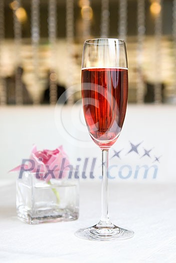 red alcohol cocktail in glass with orchid red alcohol cocktail in glass with orchid