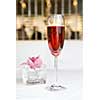 red alcohol cocktail in glass with orchid