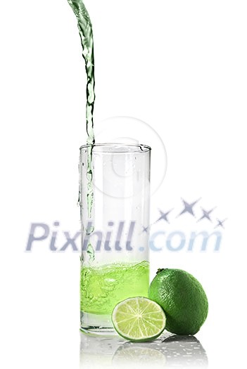green juice with lime pouring into glass isolated on white green juice with lime pouring into glass isolated on white