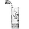 water pouring into glass from bottle isolated on white