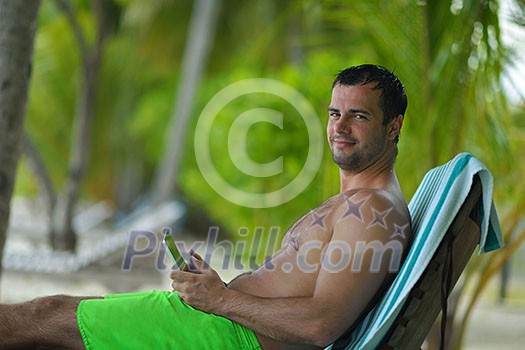 business man relaxing and use tablet computer at beautiful tropical beach business man relaxing and use tablet computer at beautiful tropical beach