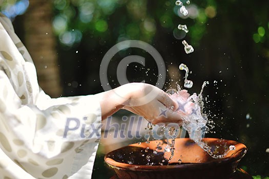splashing fresh water drops on girl soft skin care for sensuality woman hands splashing fresh water drops on girl soft skin care for sensuality woman hands