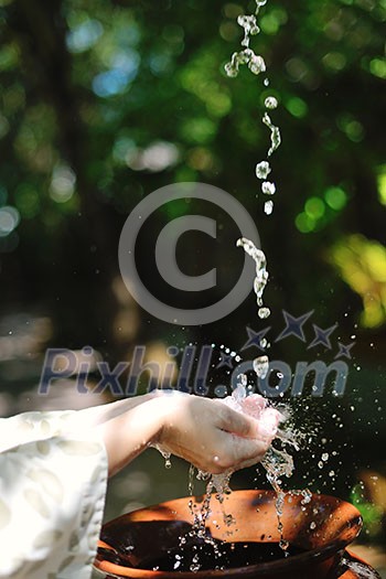 splashing fresh water drops on girl soft skin care for sensuality woman hands splashing fresh water drops on girl soft skin care for sensuality woman hands