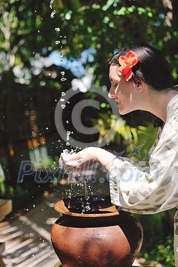 splashing fresh water drops on girl soft skin care for sensuality woman hands splashing fresh water drops on girl soft skin care for sensuality woman hands