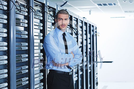 young handsome business man engeneer in datacenter server room young handsome business man engeneer in datacenter server room