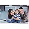 happy young family have fun and relaxing at new home with bright furniture