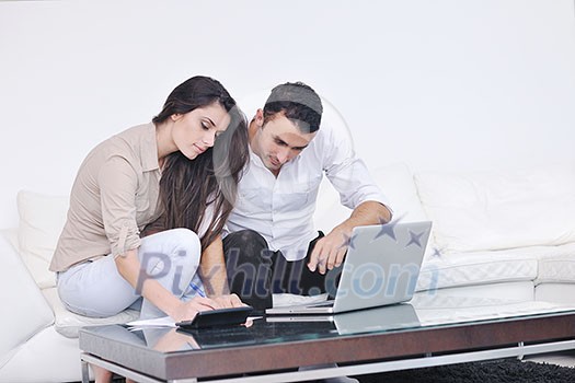 joyful couple relax and work on laptop computer at modern living room indoor home joyful couple relax and work on laptop computer at modern living room indoor home