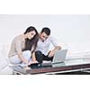 joyful couple relax and work on laptop computer at modern living room indoor home