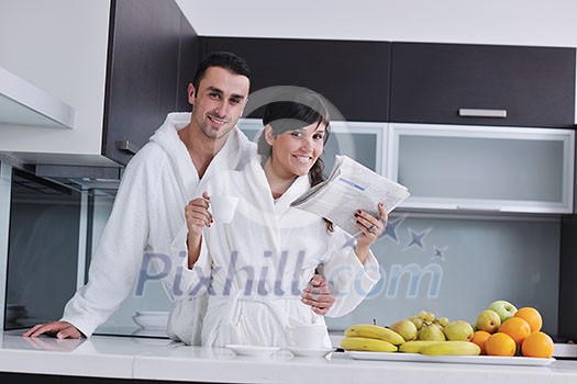 young family couple read newspaper at kitchen in morning with fresh breakfast fruits food and coffee drink on table young family couple read newspaper at kitchen in morning with fresh breakfast fruits food and coffee drink on table