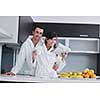 young family couple read newspaper at kitchen in morning with  fresh breakfast  fruits food and coffee drink on table