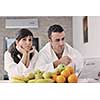 young family couple read newspaper at kitchen in morning with  fresh breakfast  fruits food and coffee drink on table