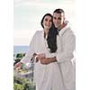 happy young couple relax on balcony outdoor with ocean and blue sky in background