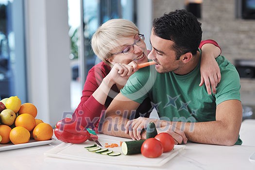 happy young couple have fun in modern kitchen indoor while preparing fresh fruits and vegetables food salad happy young couple have fun in modern kitchen indoor while preparing fresh fruits and vegetables food salad