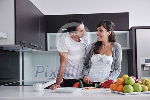 happy young couple have fun in modern kitchen indoor while preparing fresh fruits and vegetables food salad happy young couple have fun in modern kitchen indoor while preparing fresh fruits and vegetables food salad