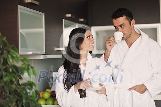 Young love couple taking fresh morning cup of coffee in the modern appartment Young love couple taking fresh morning cup of coffee in the modern appartment