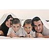 happy young Family in their bedroom have fun and play in bed