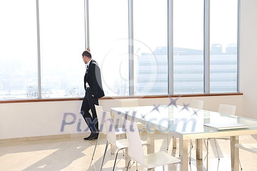 young business man lawyer with laptop alone in big bright conference room young business man lawyer with laptop alone in big bright conference room