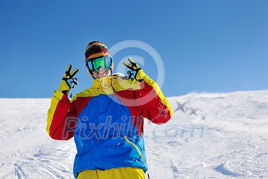 skier skiing downhill on fresh powder snow  with sun and mountains in background