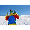 skier skiing downhill on fresh powder snow  with sun and mountains in background