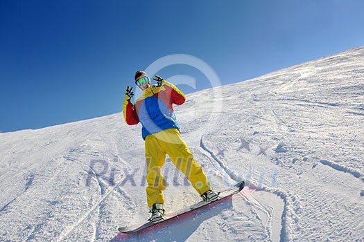skier skiing downhill on fresh powder snow with sun and mountains in background skier skiing downhill on fresh powder snow with sun and mountains in background