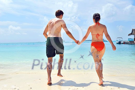 happy young romantic couple in love have fun running and relaxing on beautiful beach happy young romantic couple in love have fun running and relaxing on beautiful beach