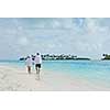 happy young romantic couple in love have fun running and relaxing on beautiful beach
