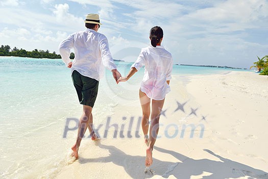 happy young romantic couple in love have fun running and relaxing on beautiful beach happy young romantic couple in love have fun running and relaxing on beautiful beach