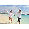 happy young romantic couple in love have fun running and relaxing on beautiful beach