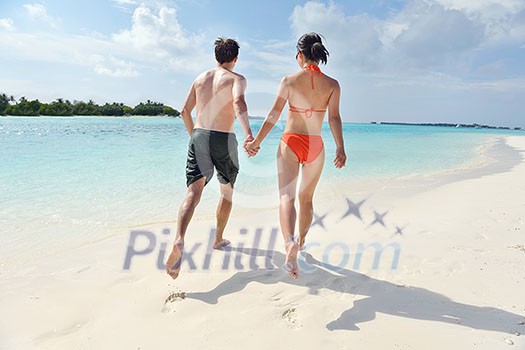 happy young romantic couple in love have fun running and relaxing on beautiful beach happy young romantic couple in love have fun running and relaxing on beautiful beach