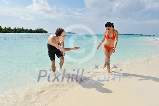 happy young romantic couple in love have fun running and relaxing on beautiful beach happy young romantic couple in love have fun running and relaxing on beautiful beach