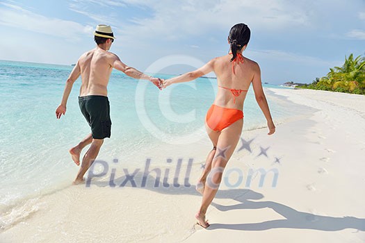 happy young romantic couple in love have fun running and relaxing on beautiful beach happy young romantic couple in love have fun running and relaxing on beautiful beach