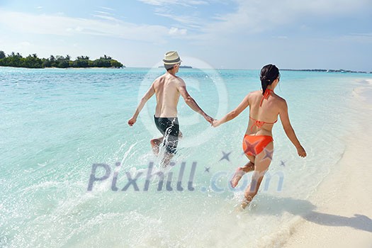 happy young romantic couple in love have fun running and relaxing on beautiful beach happy young romantic couple in love have fun running and relaxing on beautiful beach