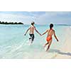 happy young romantic couple in love have fun running and relaxing on beautiful beach