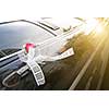 Door of black wedding car with flower and ribbon