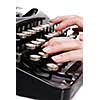 fingers on vintage typing machine on white