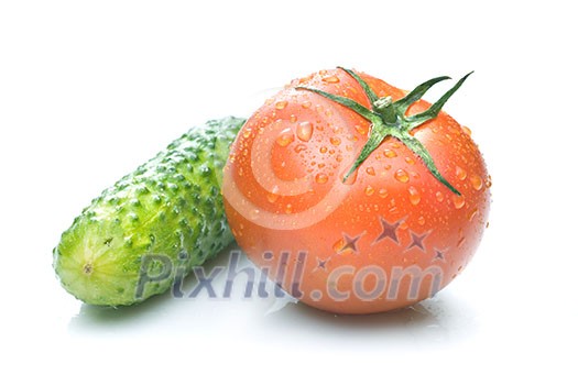 red tomato and green cucumber with water drops isolated on white red tomato and green cucumber with water drops isolated on white