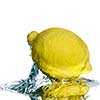 Fresh lemon on water with bubbles isolated on white
