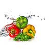 red, yellow, green pepper and parsley with water splash isolated on white