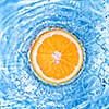 Fresh orange dropped into water with bubbles isolated on white