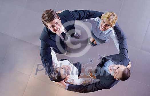 business people group joining hands and representing concept of friendship and teamwork, low angle view business people group joining hands and representing concept of friendship and teamwork, low angle view