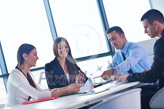 Group of happy young business people in a meeting at office Group of happy young business people in a meeting at office