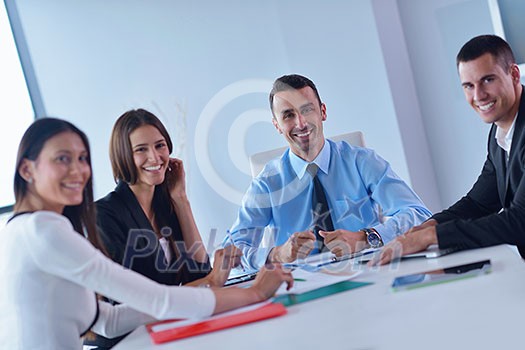 Group of happy young business people in a meeting at office Group of happy young business people in a meeting at office