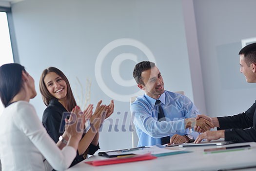 Group of happy young business people in a meeting at office Group of happy young business people in a meeting at office