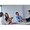 Group of happy young  business people in a meeting at office