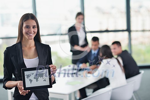 happy young business woman with her staff, people group in background at modern bright office indoors happy young business woman with her staff, people group in background at modern bright office indoors