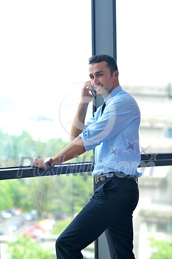 business man talking by cellphone in office business man talking by cellphone in office