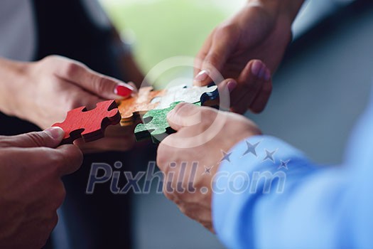 Group of business people assembling jigsaw puzzle and represent team support and help concept Group of business people assembling jigsaw puzzle and represent team support and help concept