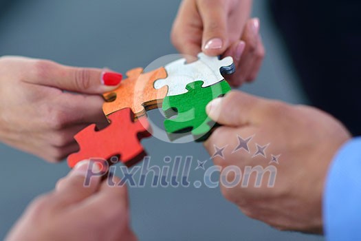 Group of business people assembling jigsaw puzzle and represent team support and help concept Group of business people assembling jigsaw puzzle and represent team support and help concept