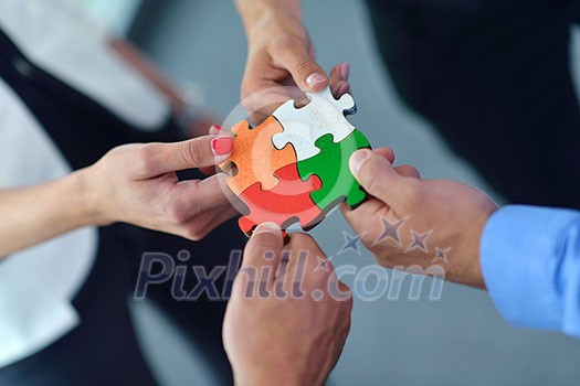 Group of business people assembling jigsaw puzzle and represent team support and help concept Group of business people assembling jigsaw puzzle and represent team support and help concept