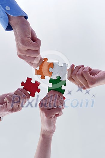 Group of business people assembling jigsaw puzzle and represent team support and help concept